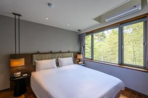 Ένα ή περισσότερα κρεβάτια σε δωμάτιο στο Howard Resort Xitou +20 φωτογραφίες