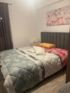 a bedroom with a bed with a quilt on it at Near for Meteora in Trikokkiá