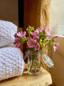 a vase of pink flowers sitting on a table at Matilde House in Fanano