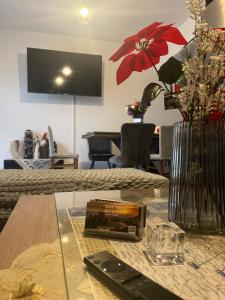 a table with a remote control and a vase with flowers at Near for Meteora in Trikokkiá