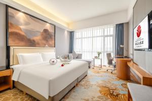 Postel nebo postele na pokoji v ubytování Zhangzhou Yuyuan Hotel