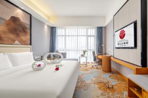 Postel nebo postele na pokoji v ubytování Zhangzhou Yuyuan Hotel