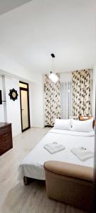 a large white bedroom with two beds in it at Isabell Home in Iaşi