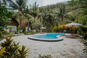 a swimming pool in front of a resort at Crystal Bay Villa in Nusa Penida