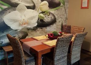 a dining room table with chairs and a flower painting at Feriendomizil Winter in Volkach