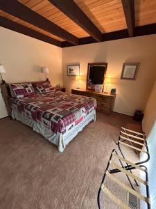 a bedroom with a large bed and a television at Rooted Resort in Kings Beach +26 photos