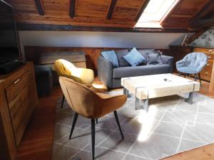a living room with a couch and a coffee table at Chaleureuse Maison de pays Serre Chevalier4étoiles in Le Monêtier-les-Bains