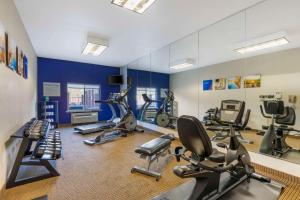 a gym with several exercise bikes and a mirror at Comfort Inn & Suites Mexia in Mexia