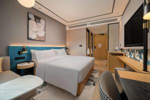Télévision ou salle de divertissement dans l'établissement Hilton Garden Inn Shanghai Caoyang