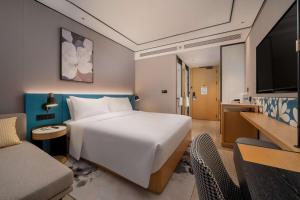 Télévision ou salle de divertissement dans l'établissement Hilton Garden Inn Shanghai Caoyang