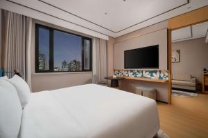 Télévision ou salle de divertissement dans l'établissement Hilton Garden Inn Shanghai Caoyang