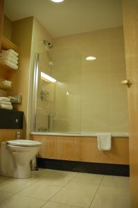 a bathroom with a toilet a sink and a shower at Magherabuoy House Hotel in Portrush