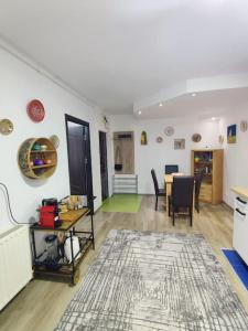 a living room with a table and a dining room at FLH - The Happy Nest - a child-friendly apartment in Sibiu