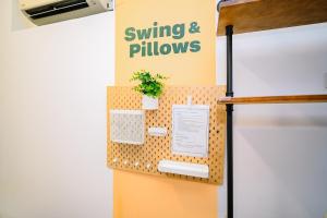 a refrigerator with a sign that reads swing and pillows at Swing & Pillows @ Beach Street in George Town