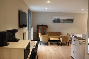 a kitchen and living room with a table and chairs at Alte Molke in Meersburg