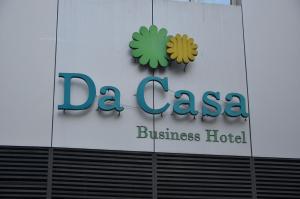 a sign for a casa business hotel on the side of a building at Da Casa Business Hotel in Pune