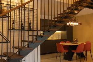 a staircase in a room with a table and chairs at Zen Villas 1 - Zen Retreat in Gnjilane