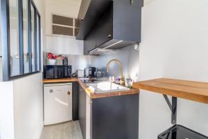 a small kitchen with a sink and a counter at Charming Studio In The Heart Of Menton in Menton