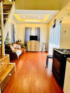 a living room with a hard wood floor and a stove at Tiny Hideaway Luna House with free 2 motorbikes in El Nido