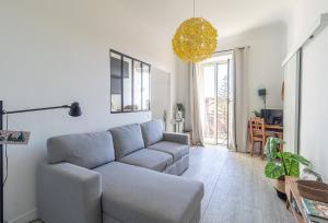 a living room with a couch and a table at Charming Studio In The Heart Of Menton in Menton