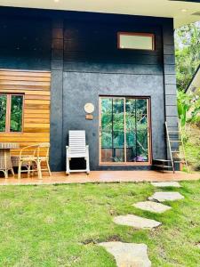 a house with a porch with a table and chairs at Tiny Hideaway Luna House with free 2 motorbikes in El Nido +39 photos