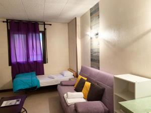 a living room with a couch and a window at Apartamentos La Cabaneta Mikka 3000 in Pas de la Casa