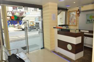 a lobby of a store with a glass door at Da Casa Business Hotel in Pune
