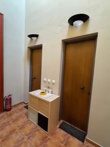 a room with a bathroom with a sink and two doors at Frigias 1 in Arachova +2 photos
