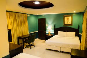 a bedroom with a bed and a desk with a desk at Dreamwave Resort Pansol Laguna in Calamba +9 photos