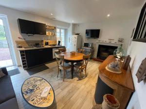 a kitchen with a table and a dining room at Petite maison dans la manche in Créances