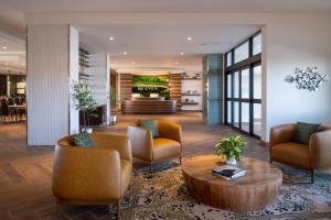 a lobby with chairs and a coffee table in a building at EVEN Hotel Bozeman Yellowstone Intl Arpt by IHG in Belgrade