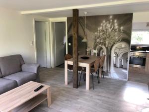 a living room with a table and a couch at Ferienhäuser am Heidesee in Halbe