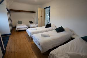 a room with three beds with white sheets at Villa Evasion in Louviers +33 photos