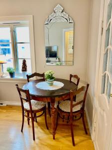 a dining room table with two chairs and a mirror at Lille Øvregate in Bergen