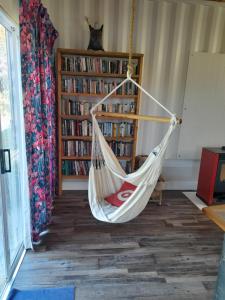 a hammock in a room with a book shelf at Butterfly House in The Crags +24 photos