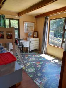 a bedroom with a bed and a desk and a window at Butterfly House in The Crags