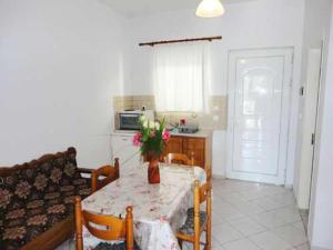 a living room with a table and a couch at Lazanis Studios Apartments in Laganas +13 photos