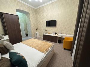 a hotel room with a bed and a bathroom at Zimmer Boutique Hotel in Baku