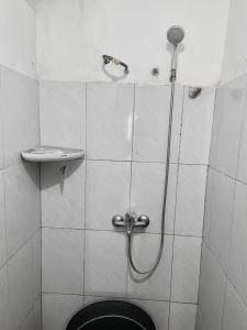 a bathroom with a shower with a toilet and a sink at Nan kanduang Homestay in Bukittinggi