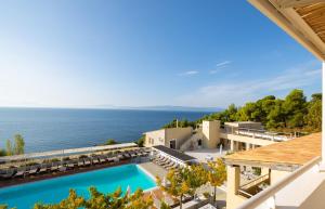 a view of a resort with a swimming pool and the ocean at Atrium Hotel in Agia Paraskevi