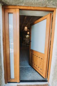 an open door with a white sign on it at La casa del Mayoral in Tremedal