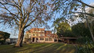 a large house with a tree in the yard at Villa Evasion in Louviers