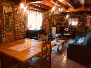 a living room with a wooden table and chairs at Posada La Herradura in Liermo