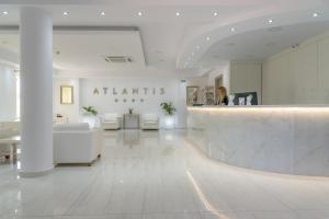 a lobby of an atantis store with white furniture at Zante Atlantis Hotel in Laganas +191 photos