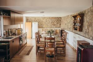 a kitchen and dining room with a table and chairs at Casa da Carvalha in Vale de Cambra