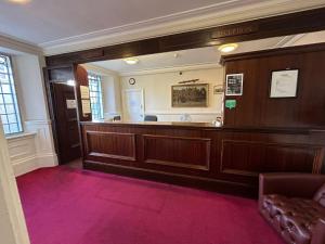 a court room with a bench and a court desk at The Hind Hotel in Wellingborough