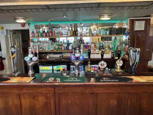 a bar with a lot of bottles of alcohol at The Hind Hotel in Wellingborough