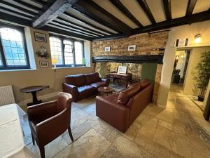 a living room with two couches and a fireplace at The Hind Hotel in Wellingborough +37 photos