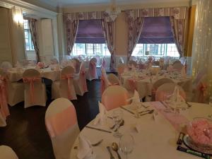 a dining room with tables and chairs with tablesktop at The Hind Hotel in Wellingborough