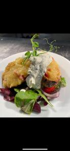 a plate of food with a sandwich and a salad at The Hind Hotel in Wellingborough